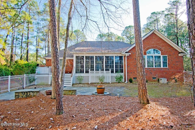 rear view of house with a patio area and a sunroom