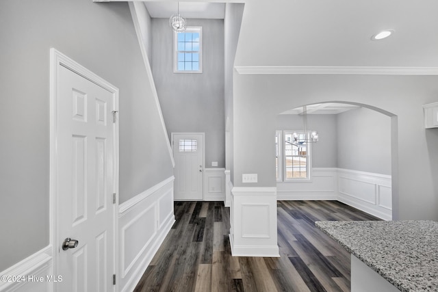 entrance foyer featuring dark wood-type flooring and an inviting chandelier