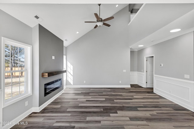 unfurnished living room featuring dark hardwood / wood-style flooring, ceiling fan, plenty of natural light, and high vaulted ceiling