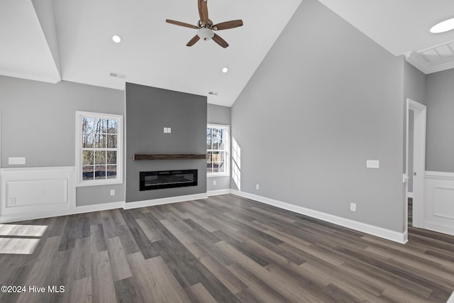 unfurnished living room with high vaulted ceiling, ceiling fan, and dark wood-type flooring