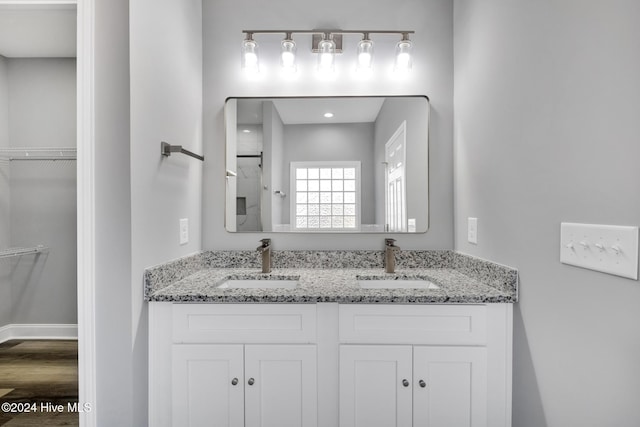 bathroom with vanity and a shower