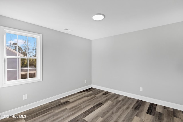 spare room featuring dark hardwood / wood-style flooring