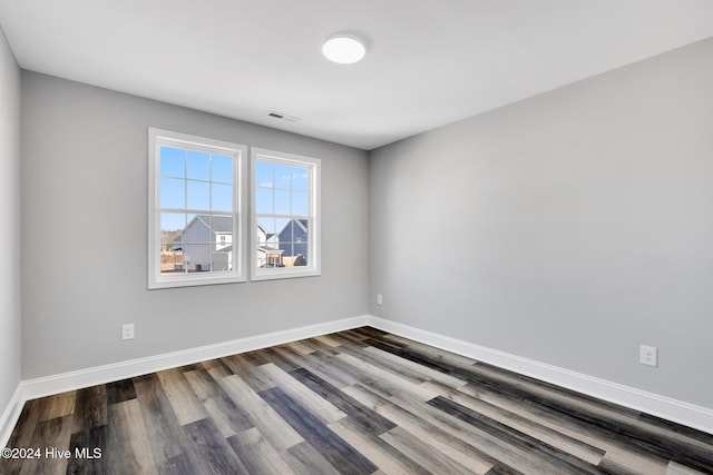 spare room with wood-type flooring