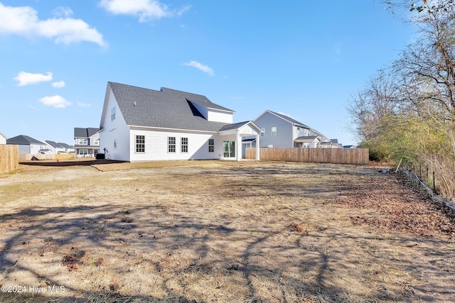 rear view of property featuring a deck