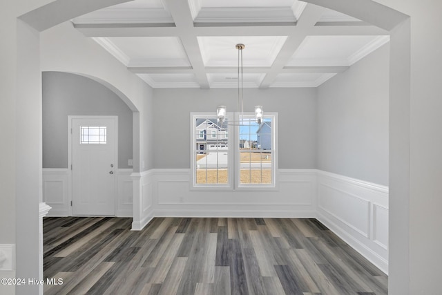 unfurnished dining area with dark hardwood / wood-style flooring, plenty of natural light, beamed ceiling, and coffered ceiling