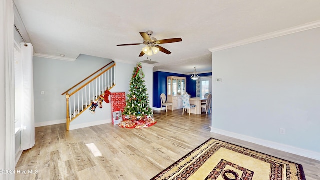 entryway featuring hardwood / wood-style flooring, ceiling fan, and crown molding