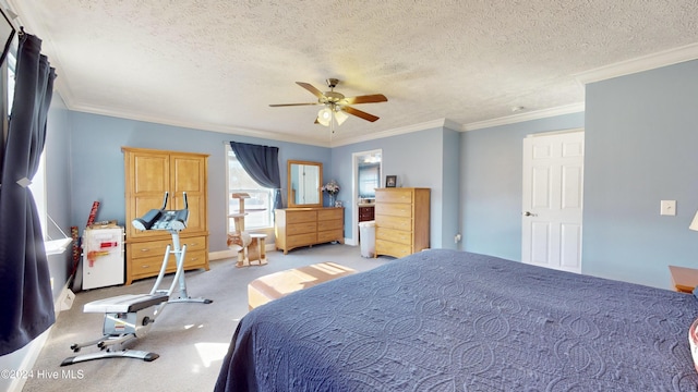 carpeted bedroom featuring a textured ceiling, ceiling fan, and ornamental molding