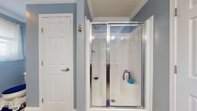 bathroom featuring a textured ceiling, toilet, an enclosed shower, and ornamental molding