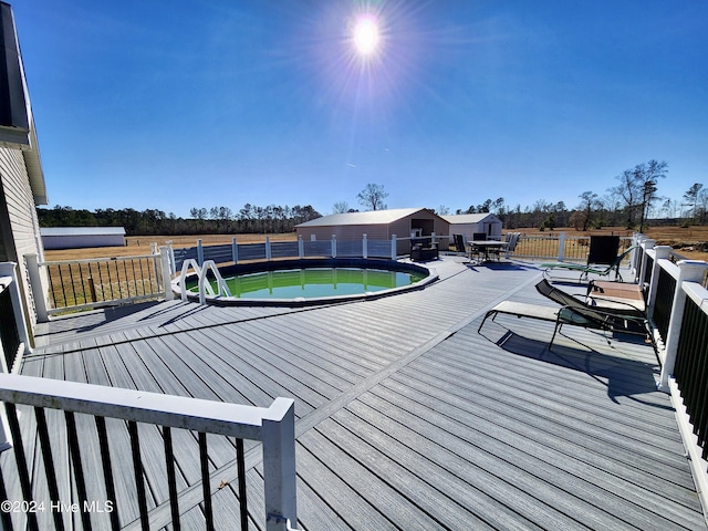 wooden terrace featuring a fenced in pool