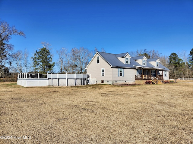 rear view of property with a lawn