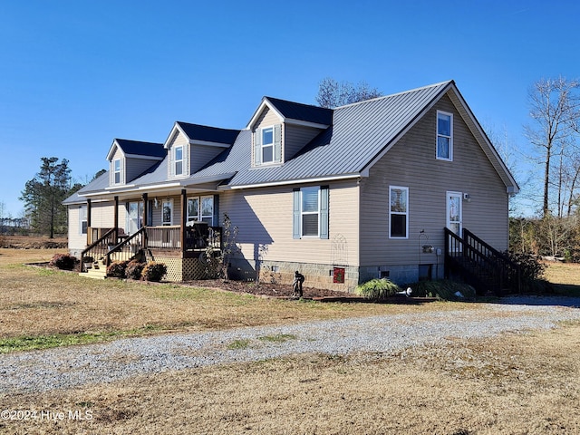 cape cod-style house featuring covered porch