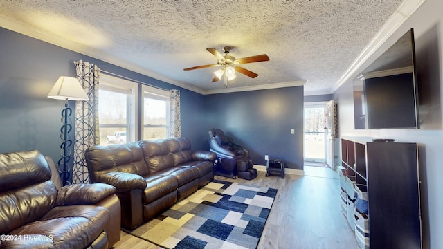 living room featuring a wealth of natural light, ornamental molding, and light wood-type flooring