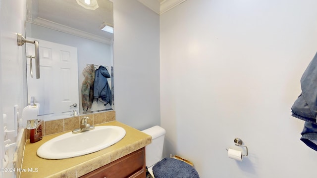 bathroom featuring vanity, toilet, and crown molding