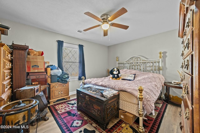 bedroom featuring ceiling fan and light hardwood / wood-style floors