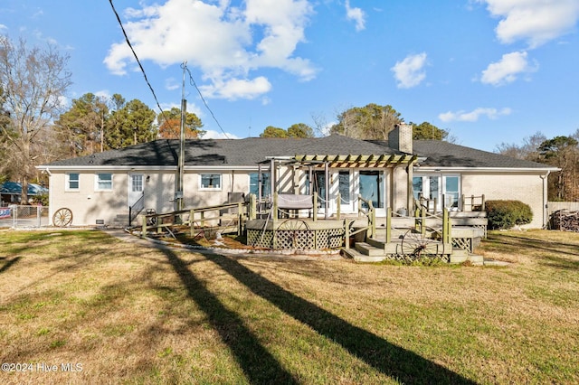 back of property with a lawn, a pergola, and a wooden deck