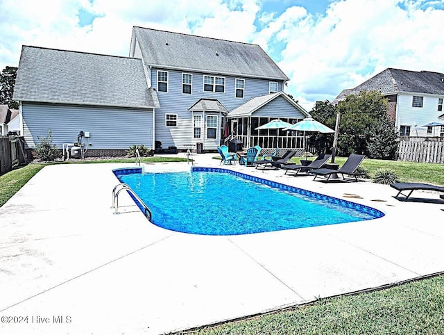 526 Rock Creek Dr N, Jacksonville, NC 28540 - view of swimming pool featuring a sunroom, a patio, and fence