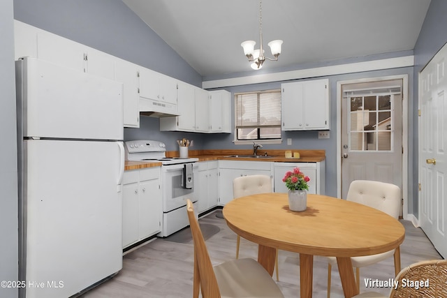 kitchen featuring pendant lighting, white appliances, white cabinetry, and vaulted ceiling