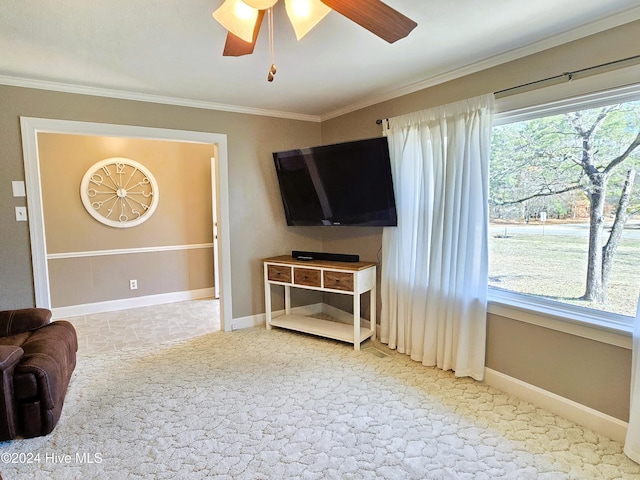 living room with a healthy amount of sunlight, ceiling fan, and crown molding