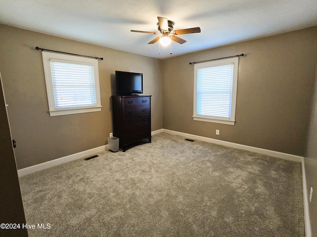 unfurnished bedroom featuring ceiling fan and light carpet