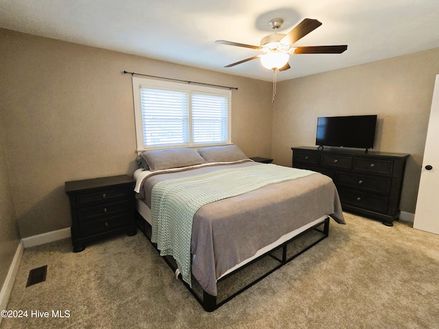 bedroom with ceiling fan and light colored carpet