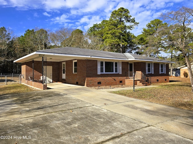 single story home featuring a carport