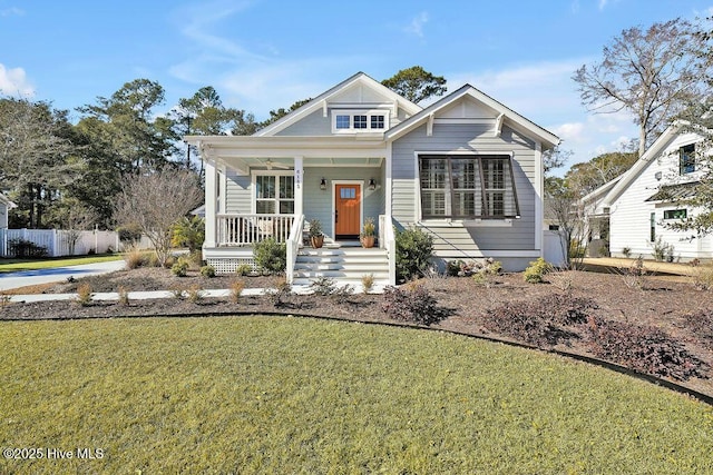 view of front of house with a porch and a front lawn