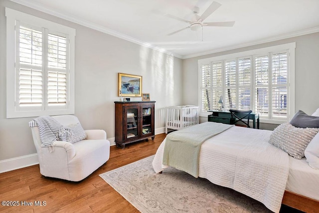 bedroom with wood-type flooring, ceiling fan, and crown molding