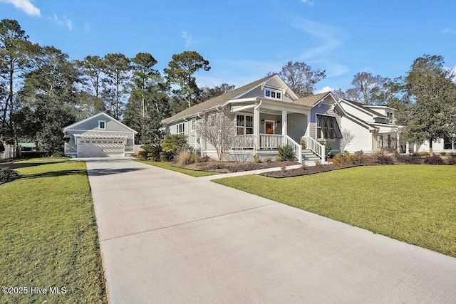 view of front of house with a porch, a garage, an outbuilding, and a front yard