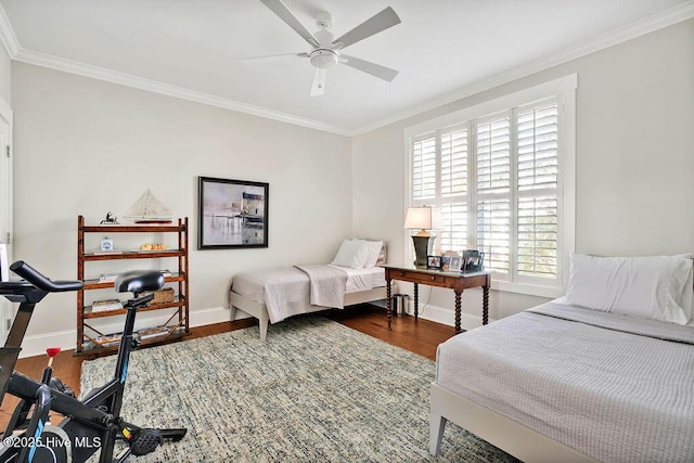 bedroom featuring ceiling fan, dark hardwood / wood-style flooring, crown molding, and multiple windows