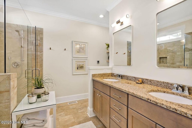 bathroom featuring vanity, a shower with shower door, and ornamental molding