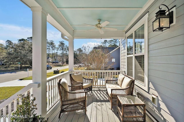 wooden deck with covered porch and ceiling fan