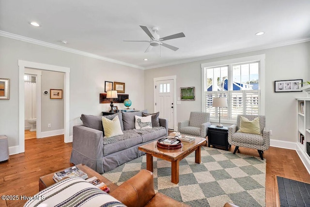 living room with ceiling fan, light hardwood / wood-style floors, and crown molding