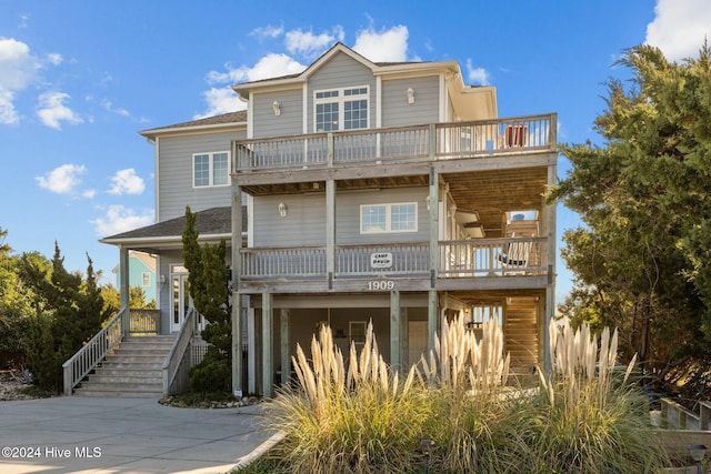 beach home featuring a balcony and a carport