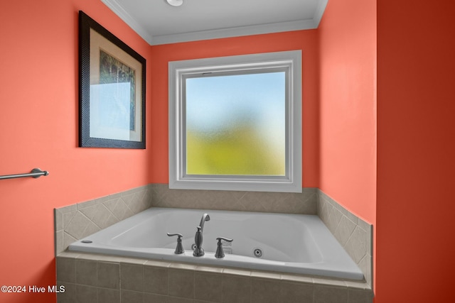 bathroom with crown molding and a relaxing tiled tub