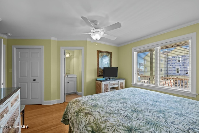 bedroom with light hardwood / wood-style flooring, ceiling fan, ornamental molding, connected bathroom, and a closet