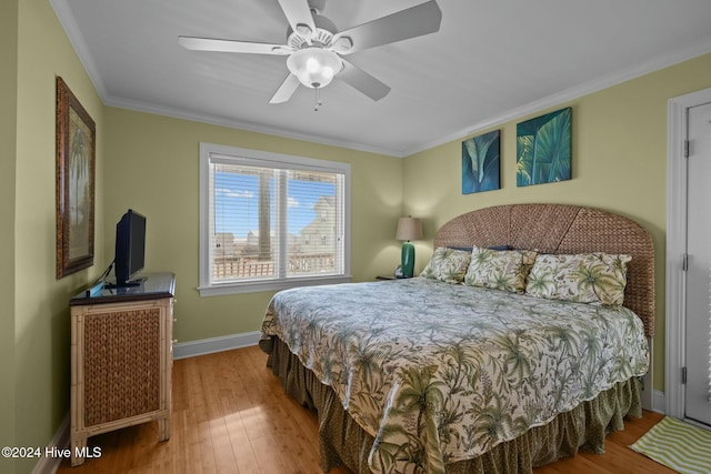 bedroom with ceiling fan, wood-type flooring, and crown molding