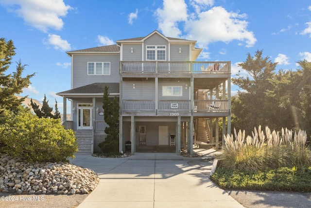 view of front of house featuring a balcony and a carport