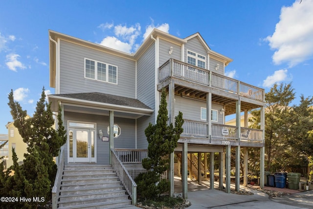 raised beach house with a carport and a porch