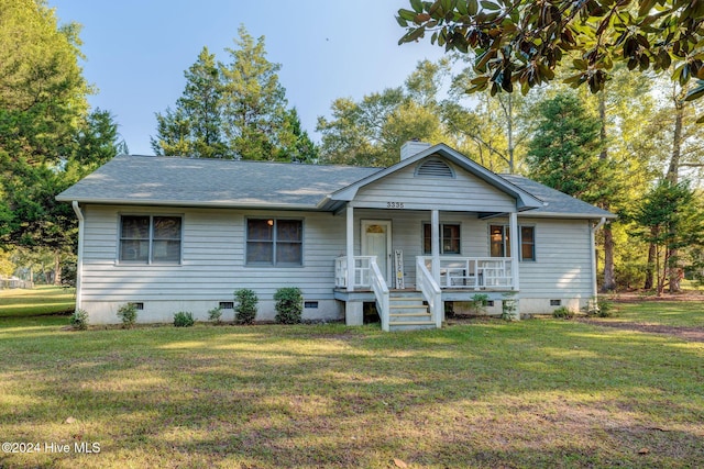 view of front of home featuring a front lawn and covered porch