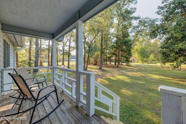 wooden deck with a porch and a yard