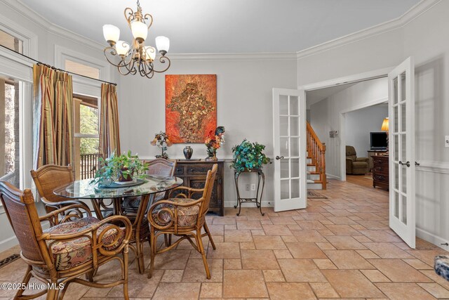 7 Brinyan Ct, Pinehurst, NC 28374 - dining space with french doors, stone tile flooring, a chandelier, ornamental molding, and stairs