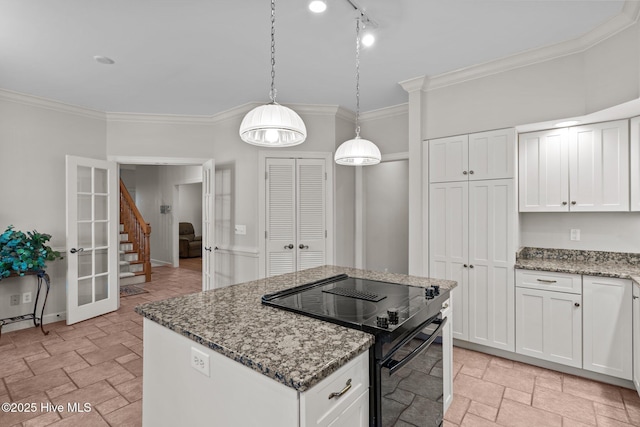 7 Brinyan Ct, Pinehurst, NC 28374 - kitchen featuring black electric range oven, ornamental molding, stone countertops, light stone finish flooring, and a center island