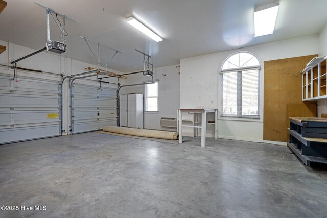 7 Brinyan Ct, Pinehurst, NC 28374 - garage featuring a garage door opener and a wall unit AC