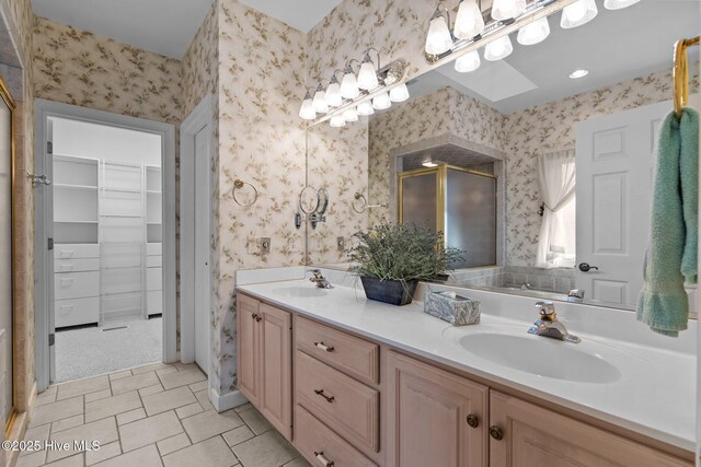 7 Brinyan Ct, Pinehurst, NC 28374 - bathroom with wallpapered walls, double vanity, a shower with door, a spacious closet, and tile patterned flooring