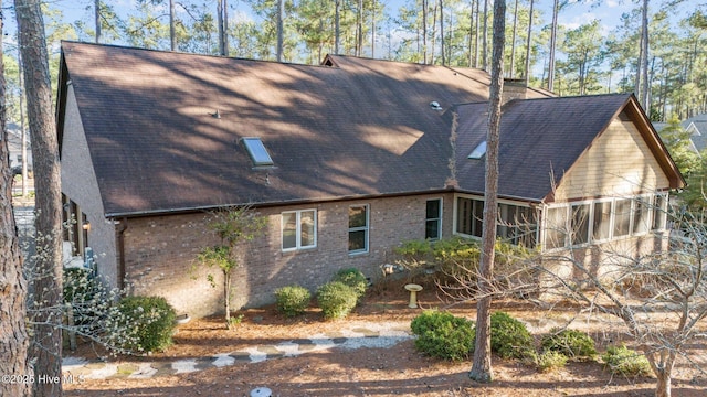 7 Brinyan Ct, Pinehurst, NC 28374 - view of home's exterior featuring roof with shingles and brick siding