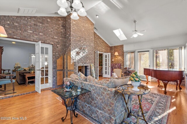 7 Brinyan Ct, Pinehurst, NC 28374 - living room featuring french doors, high vaulted ceiling, wood finished floors, a ceiling fan, and brick wall