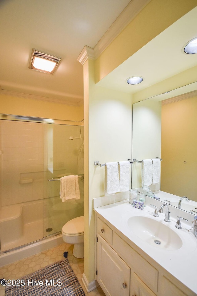 bathroom with vanity, tile patterned flooring, toilet, ornamental molding, and an enclosed shower