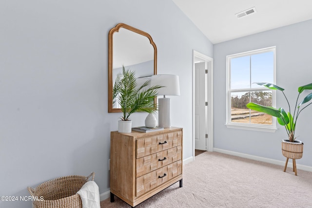 sitting room featuring visible vents, baseboards, lofted ceiling, and carpet flooring