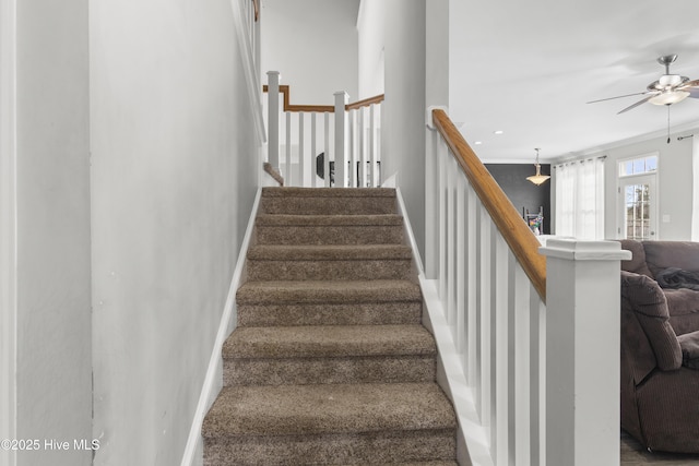 stairway with ornamental molding and ceiling fan