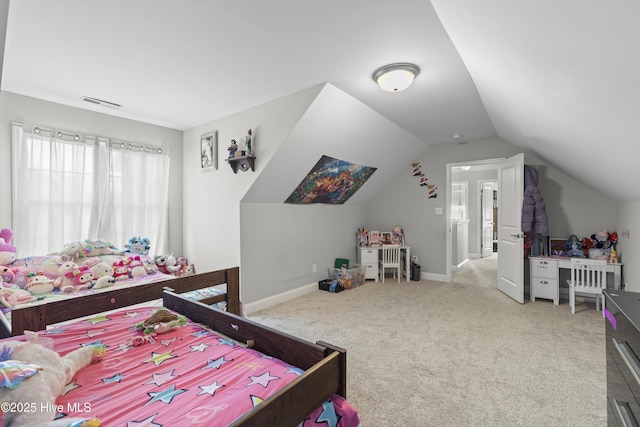 carpeted bedroom with lofted ceiling